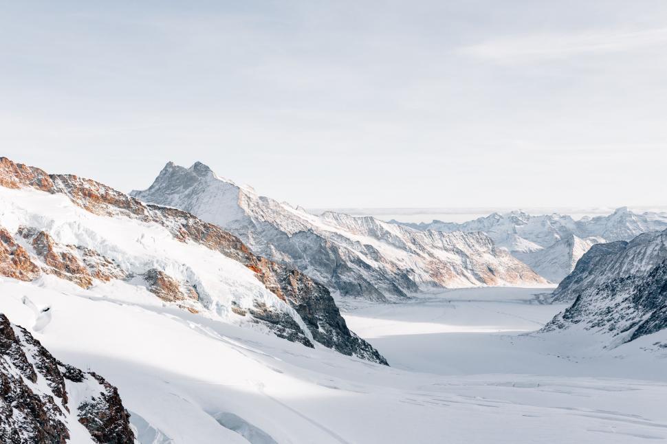 Free Image of Snow-covered mountain peak under blue sky 