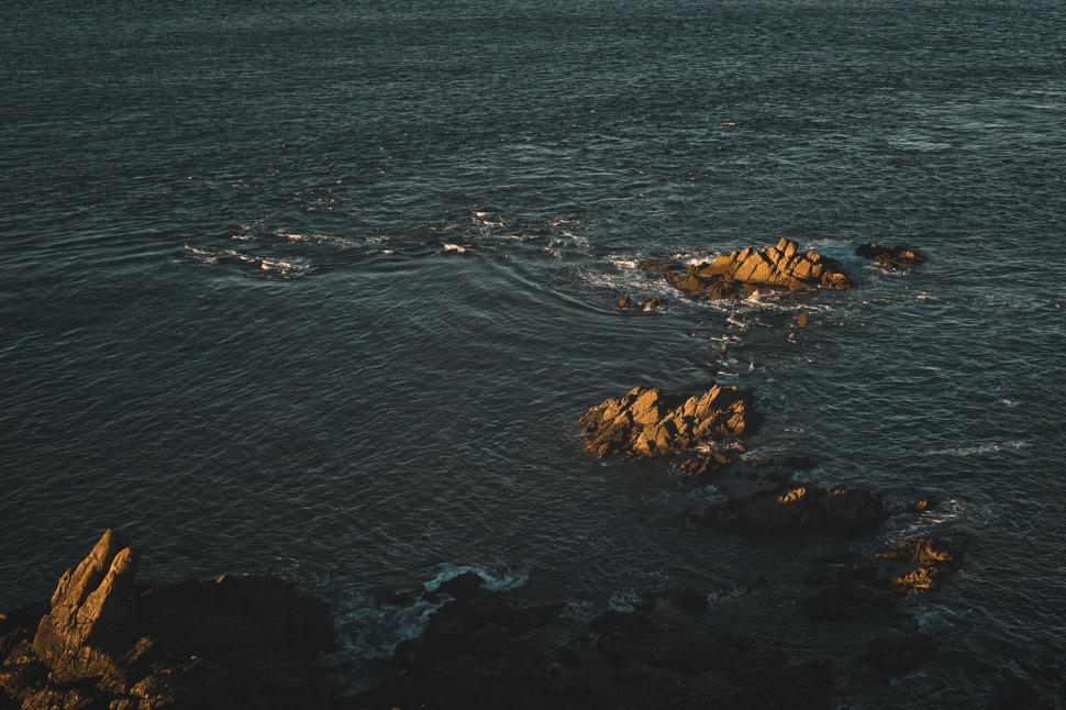 Free Image of Golden hour light on rocky sea coast 