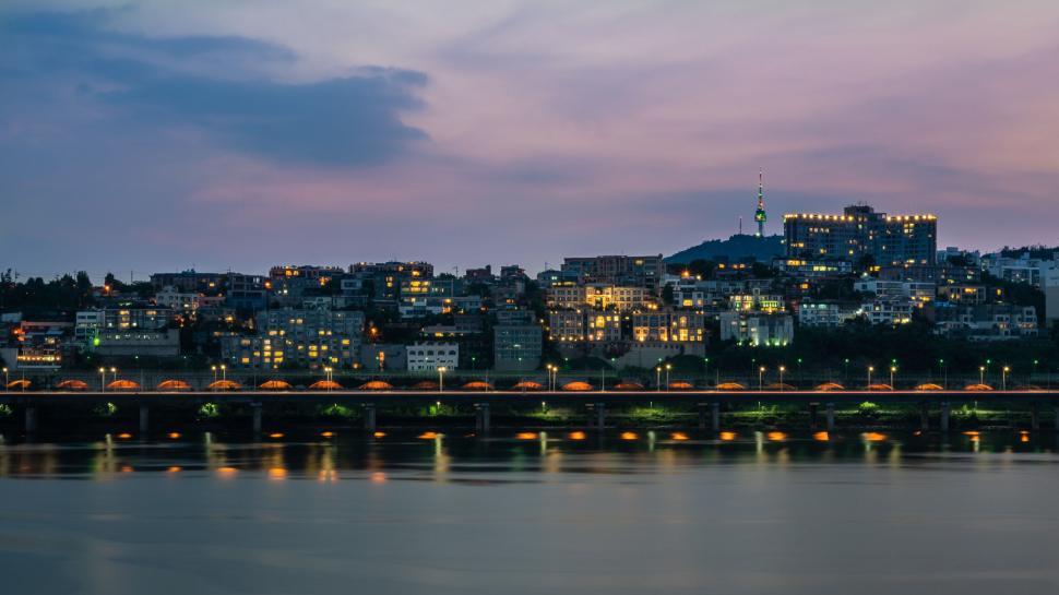 Free Image of Twilight cityscape with illuminated bridge 