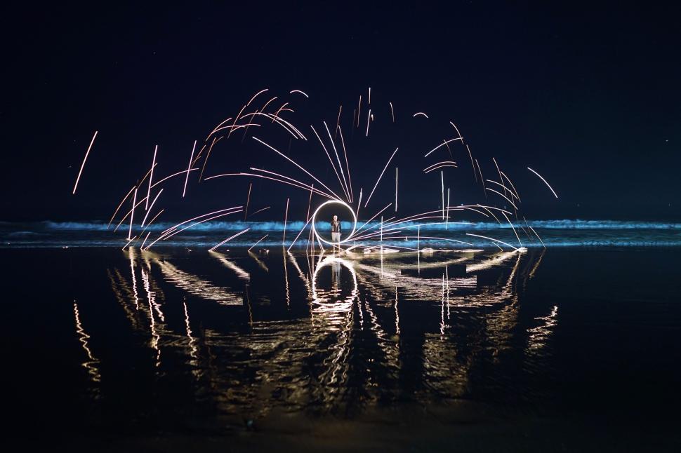 Free Image of Sparkling beach night with light trails 