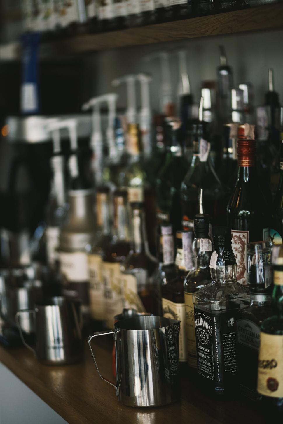 Free Image of Assorted liquor bottles on a bar shelf 