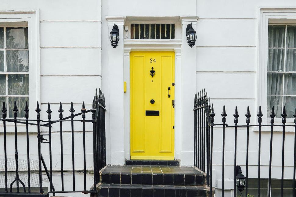 Free Image of Vibrant yellow door on classic townhouse 