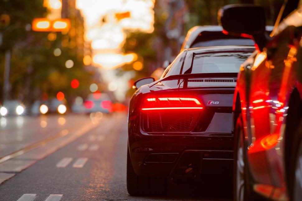 Free Image of Luxury car on city street at sunset 