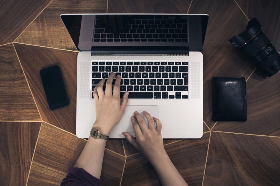 Free Image of Person working on laptop with accessories 