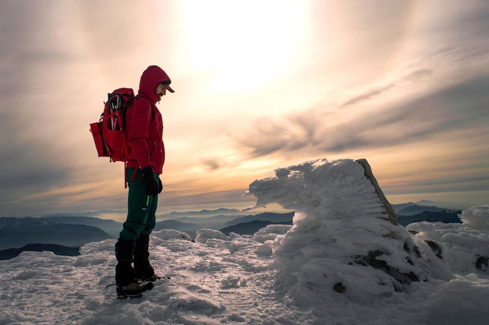 Free Image of Mountain climber at sunrise on snowy peak 
