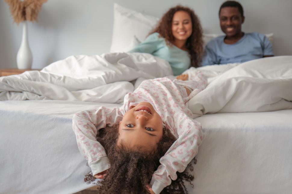 Free Image of Child with upside-down view in bed 