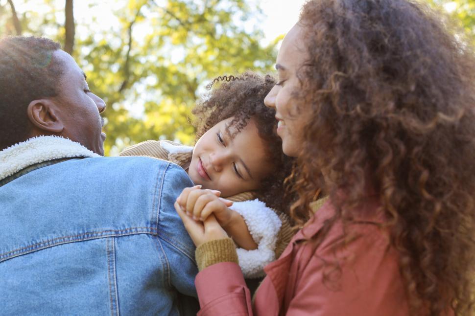 Free Image of Family from behind holding hands in nature 