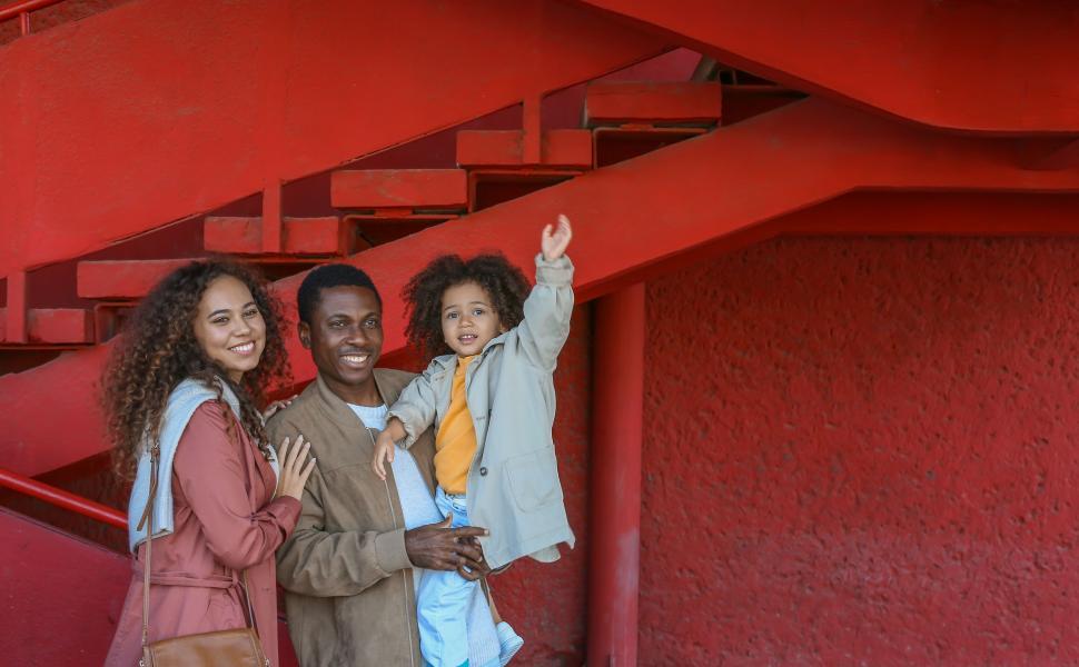 Free Image of Happy family by red staircase 