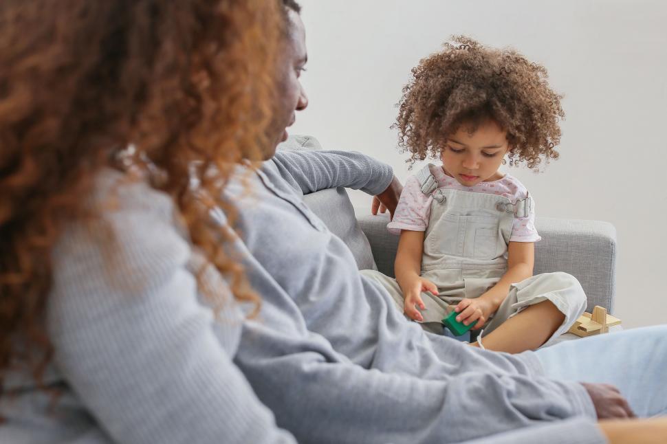 Free Image of Mom and child playing with blocks on sofa 