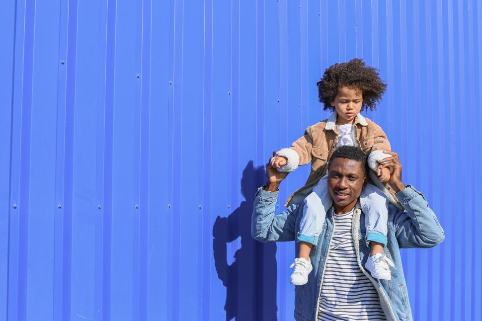 Free Image of Father carrying daughter on his shoulders 