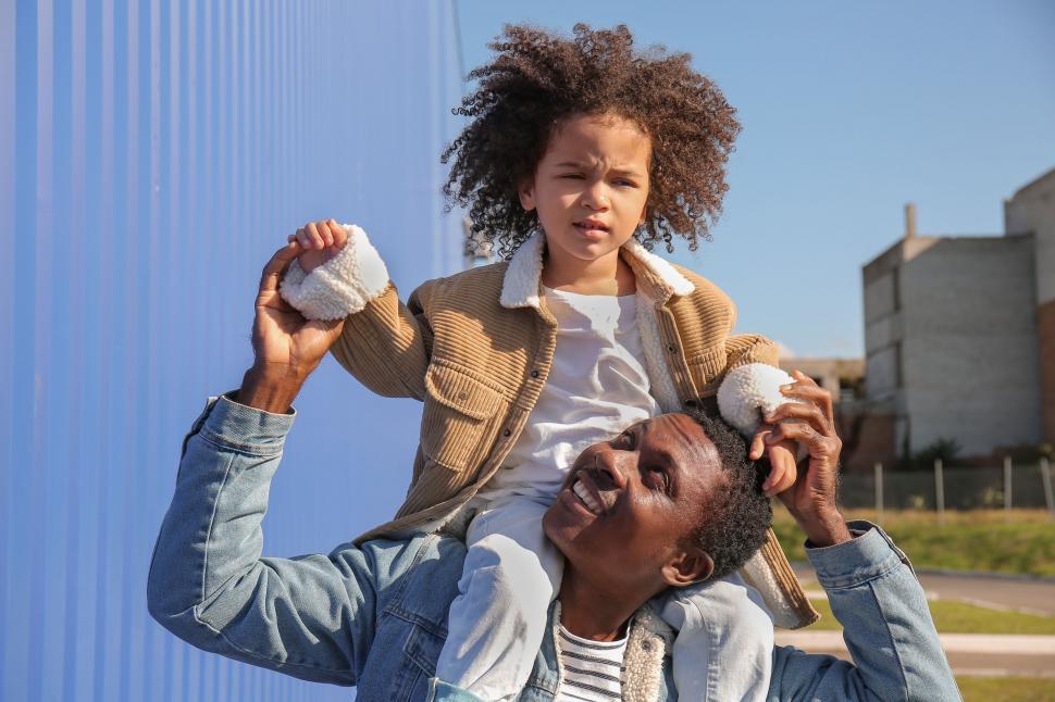 Free Image of Father lifting daughter in the air 