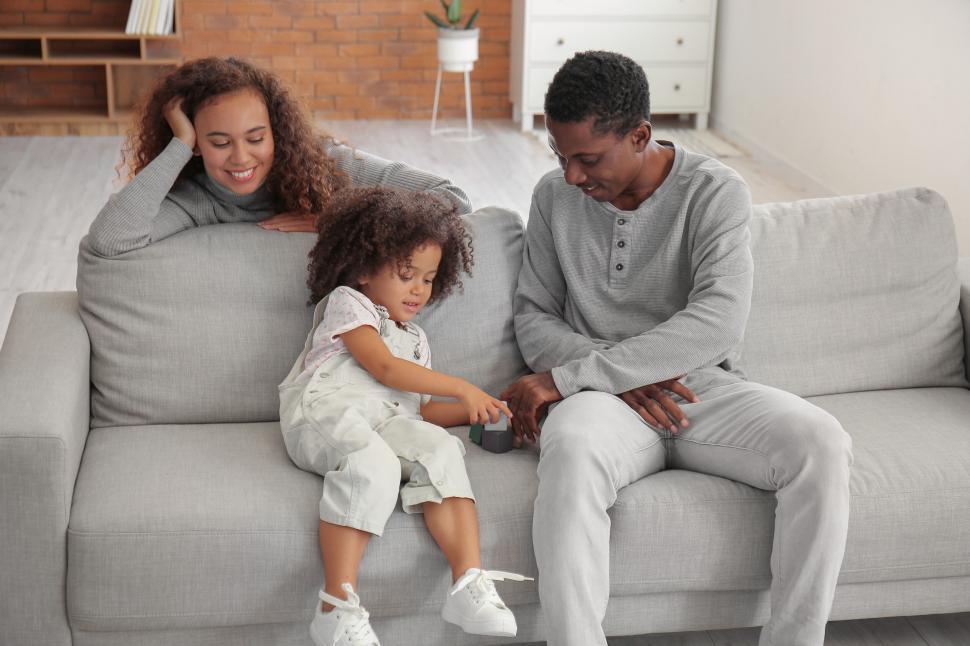 Free Image of Family relaxing together on a sofa 