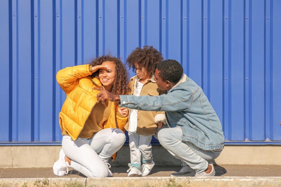 Free Image of Family squatting and looking at distance 