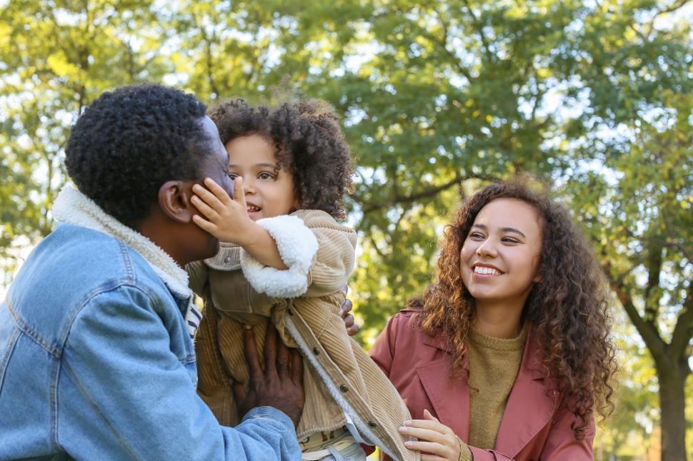 Free Image of Family sharing a whisper in the park 