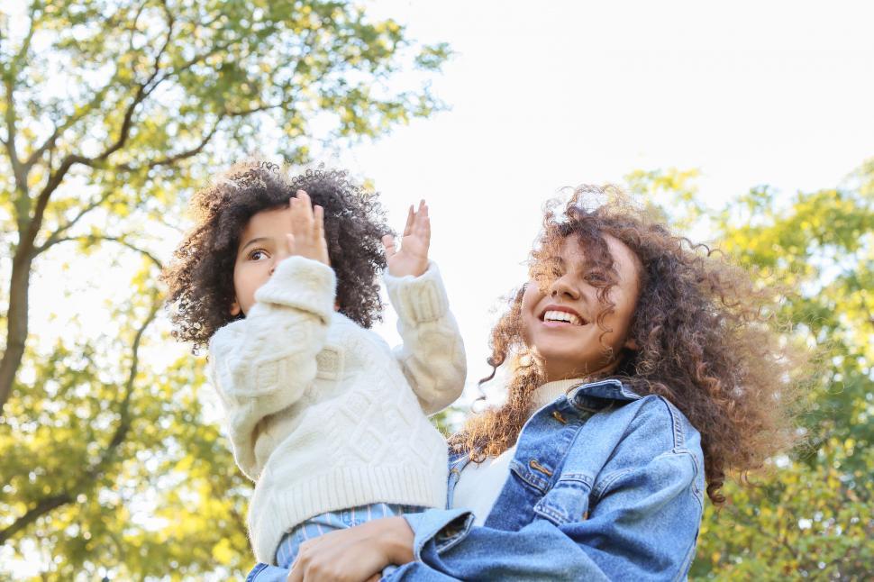 Free Image of Two children playing with autumn leaves 