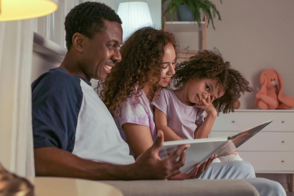 Free Image of Family reading together in a cozy setting 