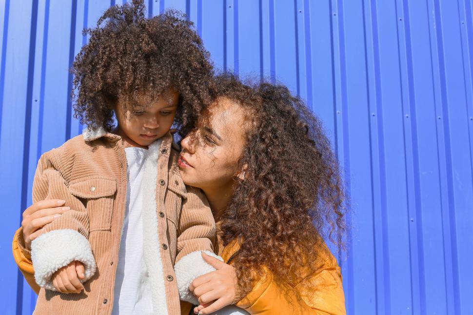 Free Image of Mother and child against blue background 