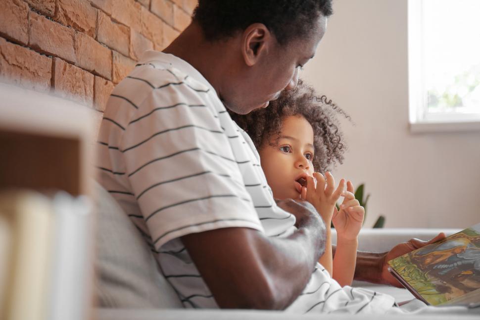 Free Image of Father and daughter reading a book 