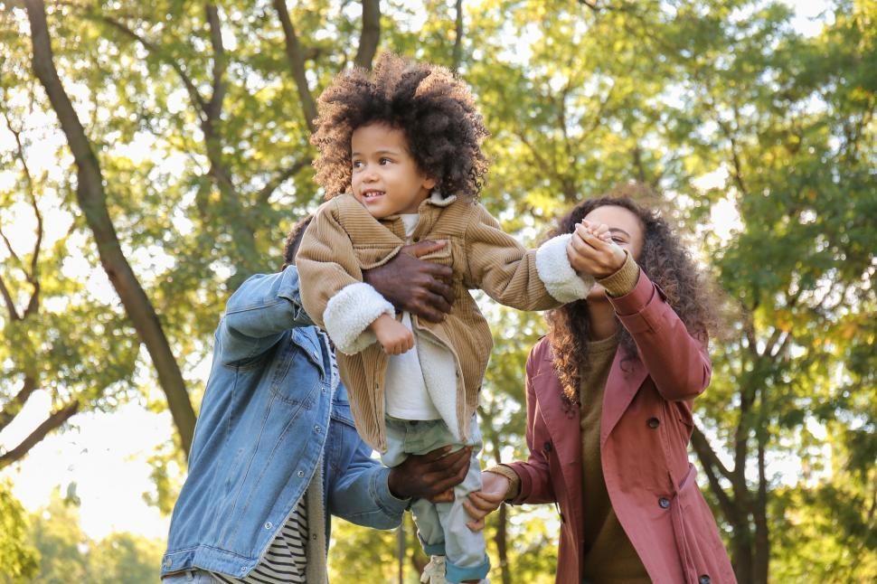 Free Image of Family enjoying outdoor playtime in park 