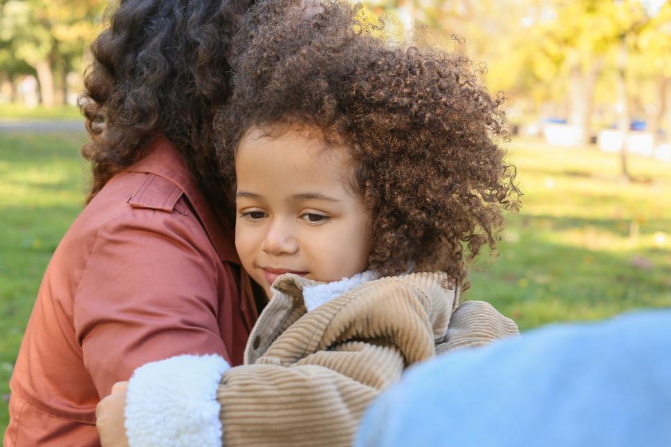 Free Image of Child receiving comfort from mother in park 
