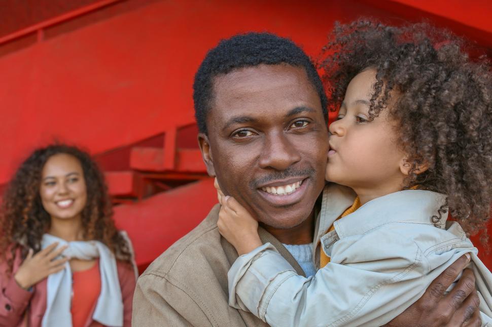 Free Image of Daughter kissing father with family 