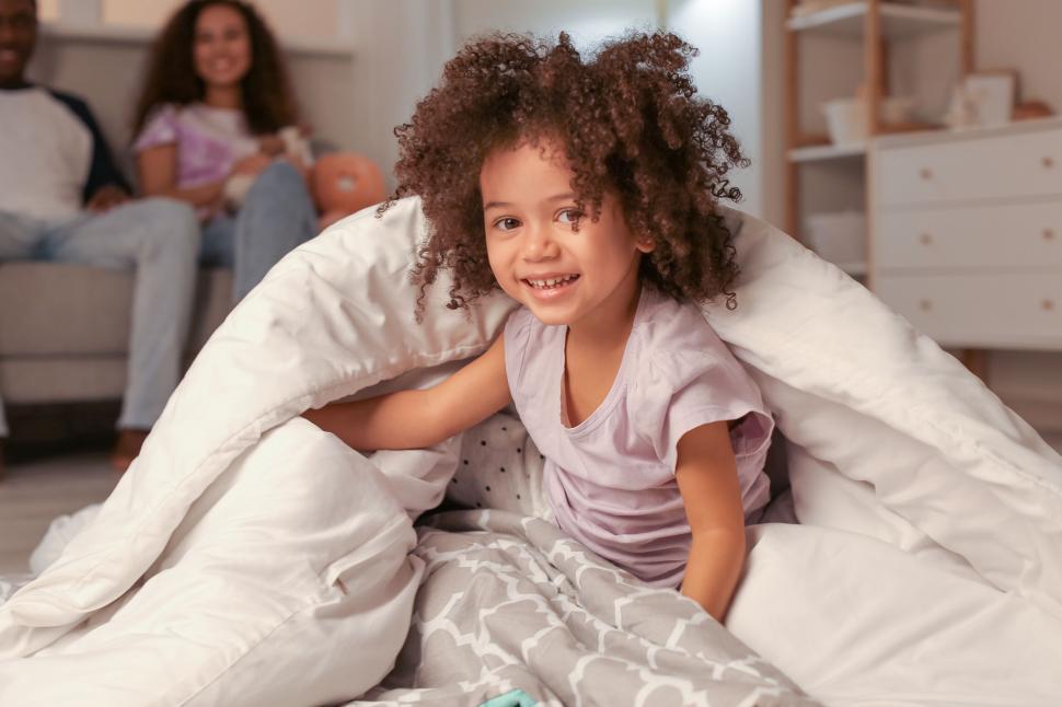 Free Image of Happy child playing under a duvet 