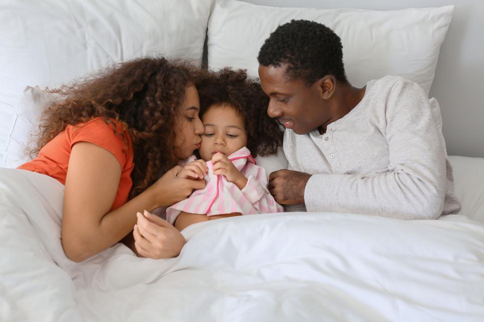 Free Image of Loving family moment in bed 