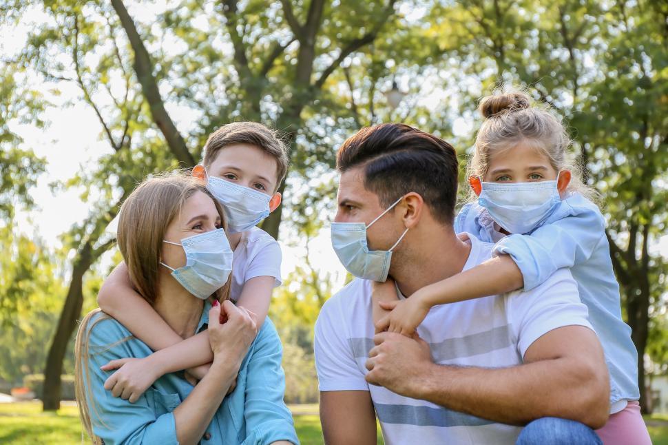 Free Image of Family outdoors lovingly embracing 