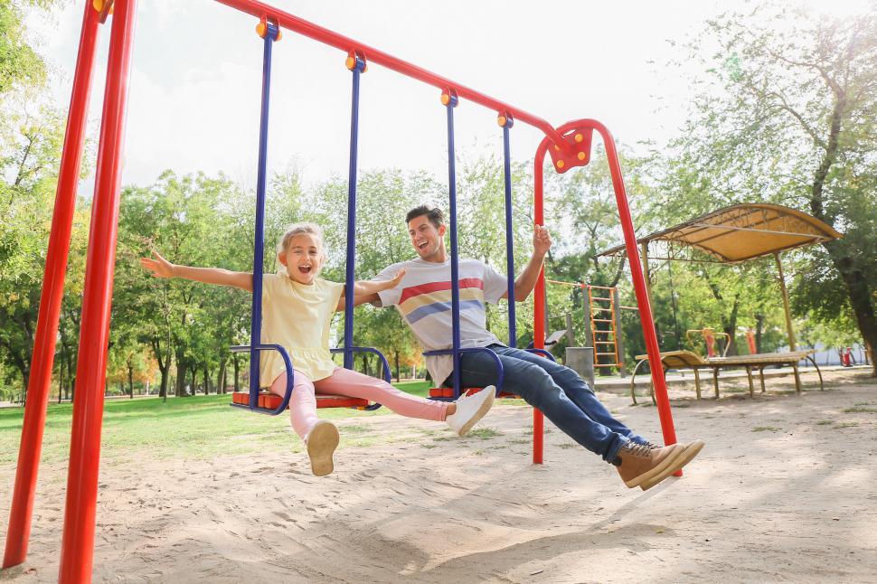 Free Image of Father daughter swinging on playground happy 