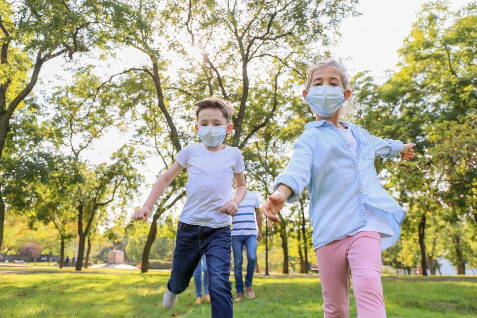 Free Image of Children running happily with a dog in a park 