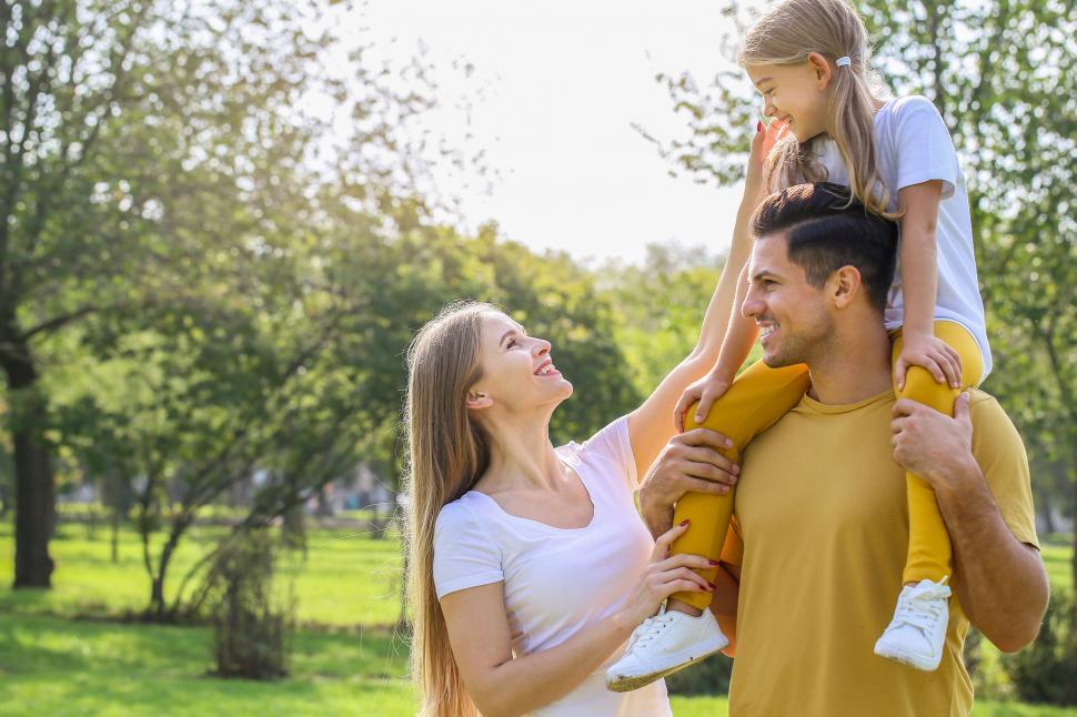 Free Image of Family embracing in vibrant park scene 