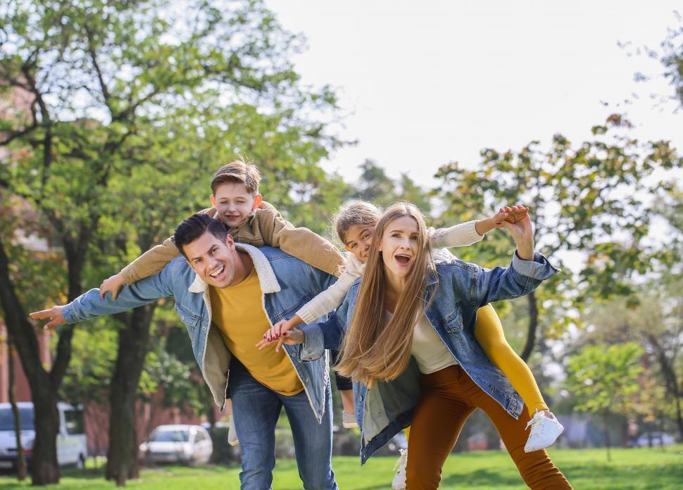 Free Image of Parents carrying kids piggyback style 