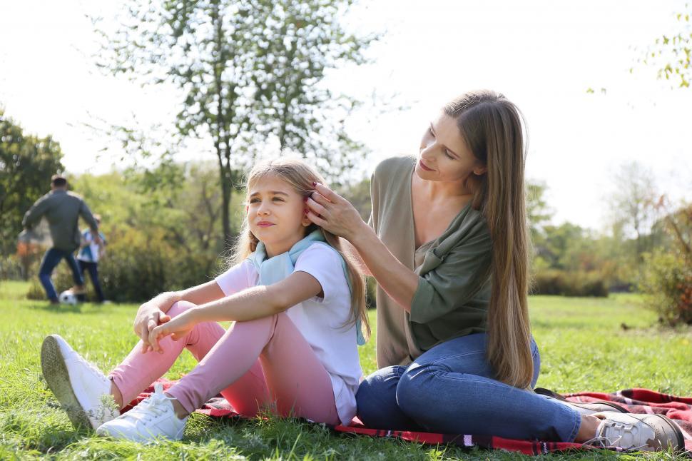 Free Image of Mother fixing daughter s hair in park 