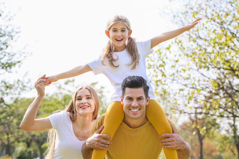 Free Image of Family piggyback ride in open park 