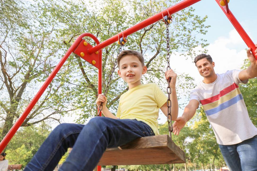 Free Image of Boy enjoying a swing ride in the park 