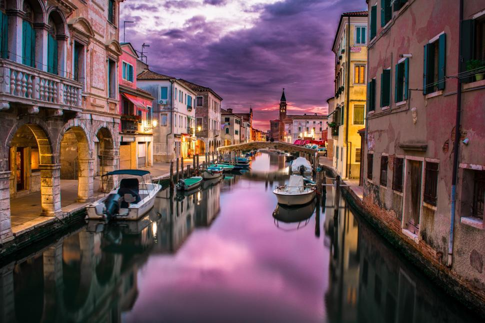 Free Image of Venetian canal with dramatic sunset sky 