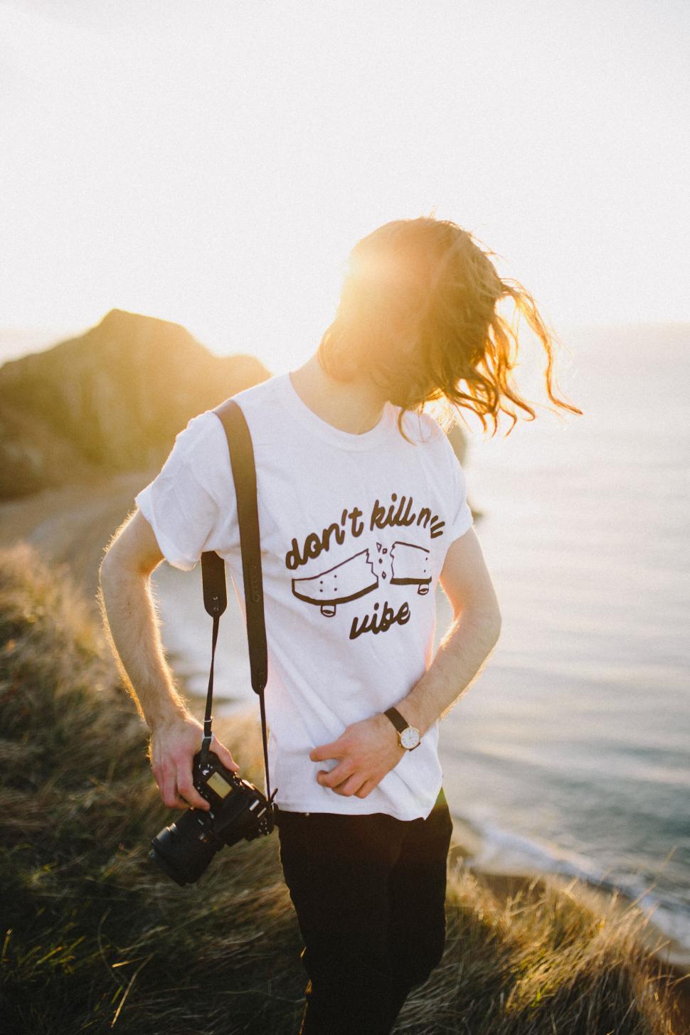 Free Image of Man with camera against sunset 