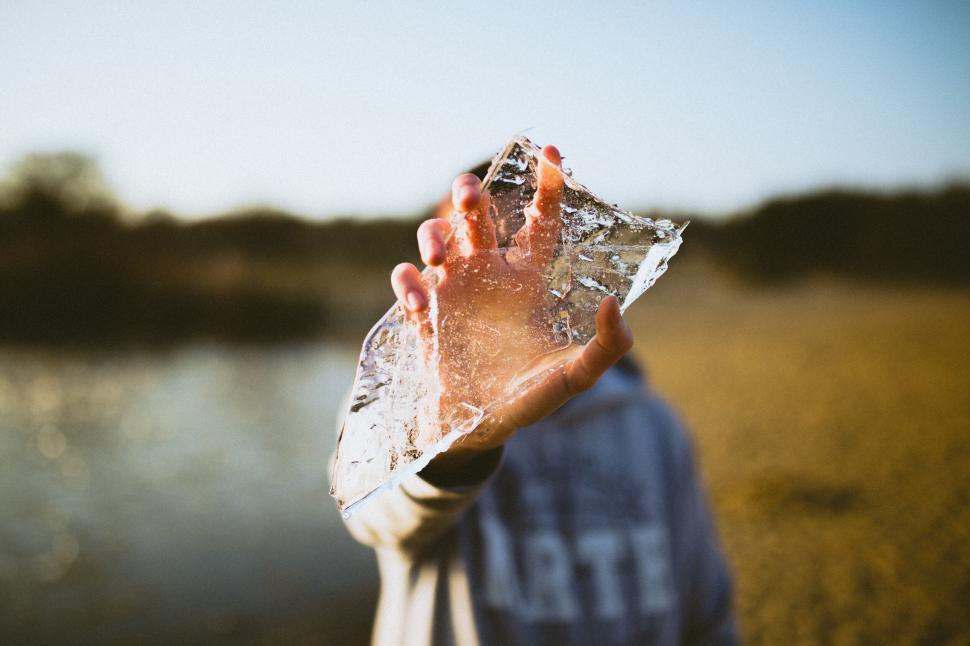 Free Image of Person holding a large ice shard in sunlight 
