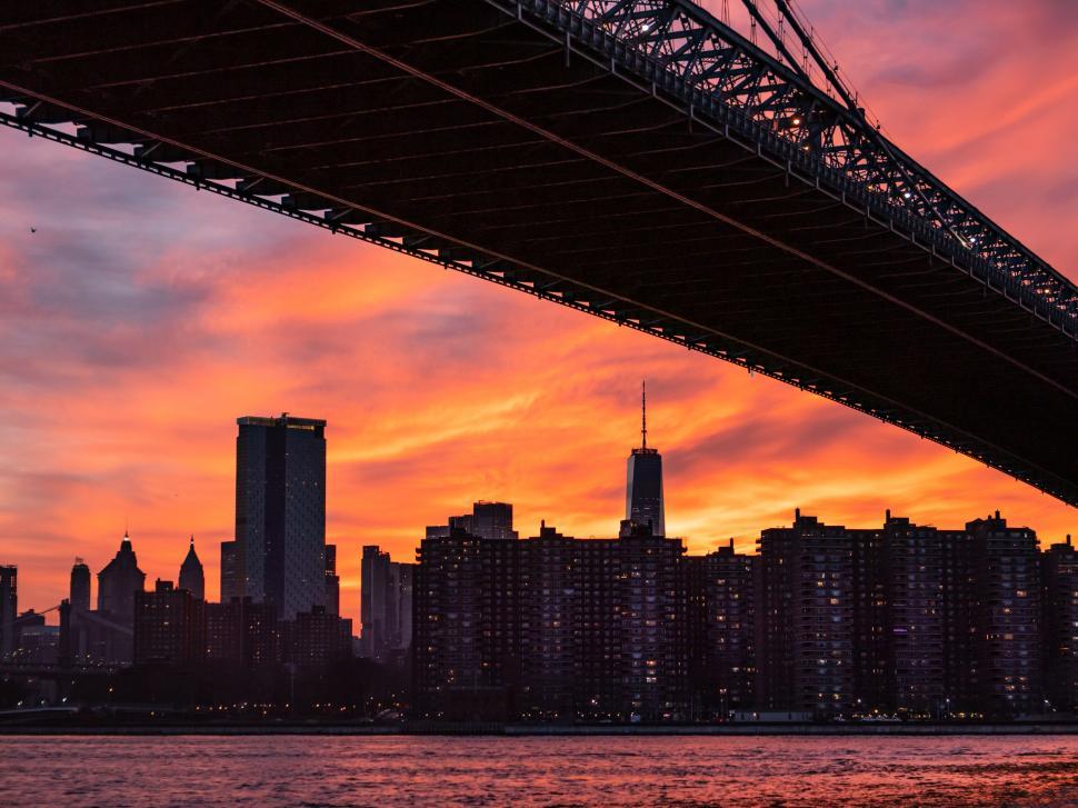 Free Image of Sunset sky with city skyline and bridge 