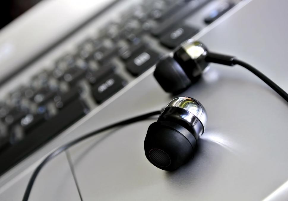 Free Image of Close-up of earbuds on a sleek surface 
