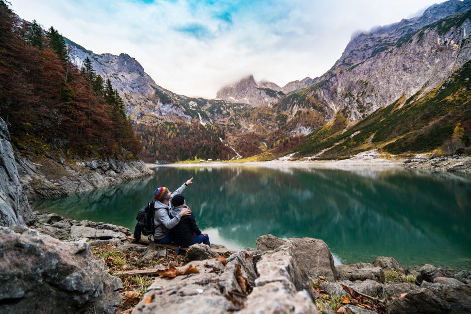 Free Image of Couple admiring alpine lake and mountains 