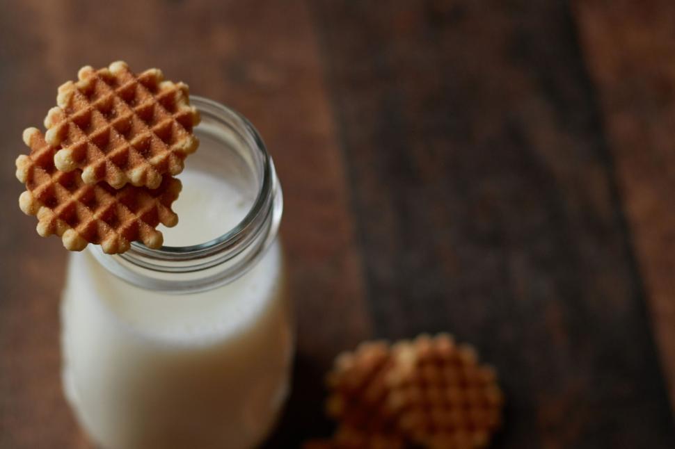 Free Image of Milk bottle with cookies on rustic wood 