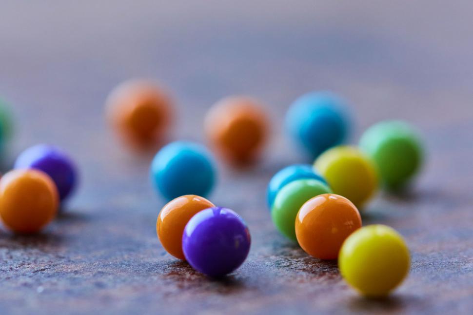 Free Image of Colorful round candies spread on surface 