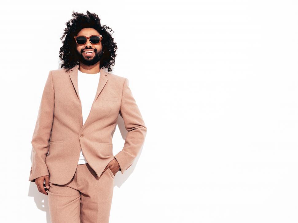 Free Image of A man wearing a suit and sunglasses 