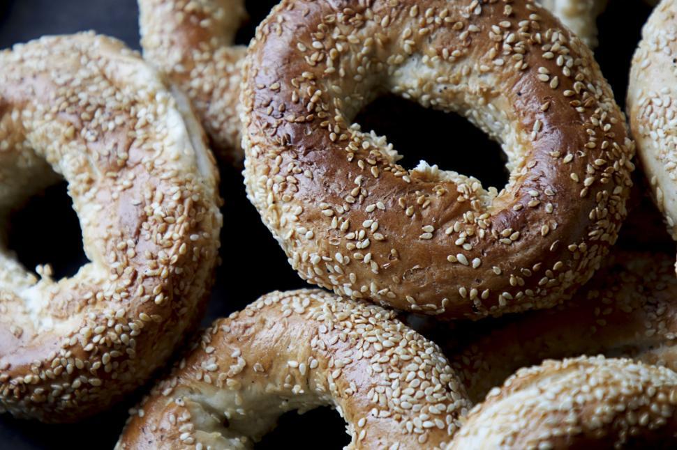 Free Image of Sesame seed bagels piled up in natural light 