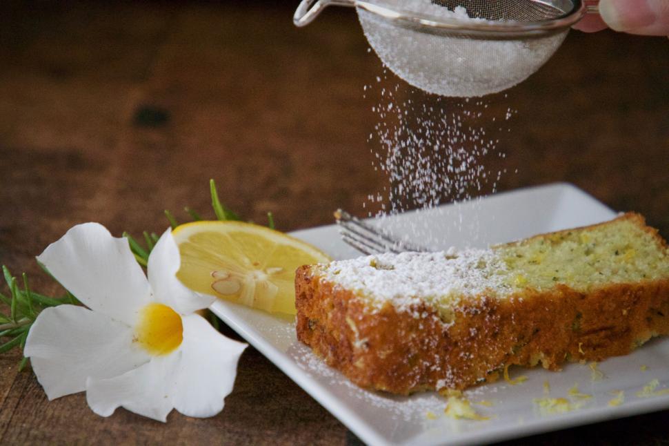 Free Image of Sugaring a slice of lemon cake 