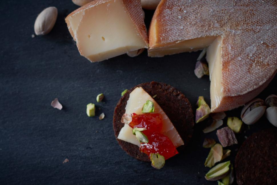 Free Image of Artisan cheese on a cracker with topping 