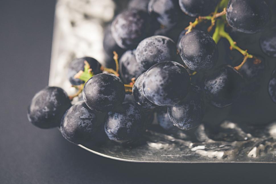 Free Image of Fresh black grapes on marble tray 
