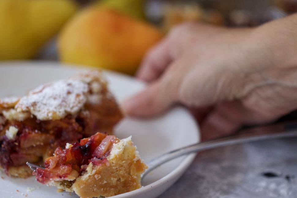 Free Image of Person eating a piece of pie 