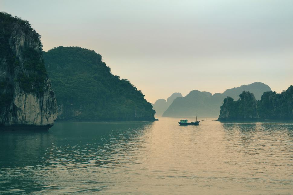 Free Image of Tranquil bay view with limestone hills 